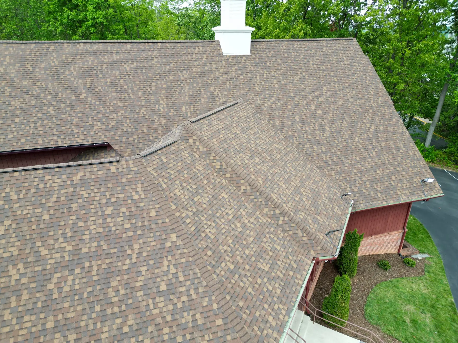 Close-up drone view of new shingles and valleys on a church roof in Johnson City, TN