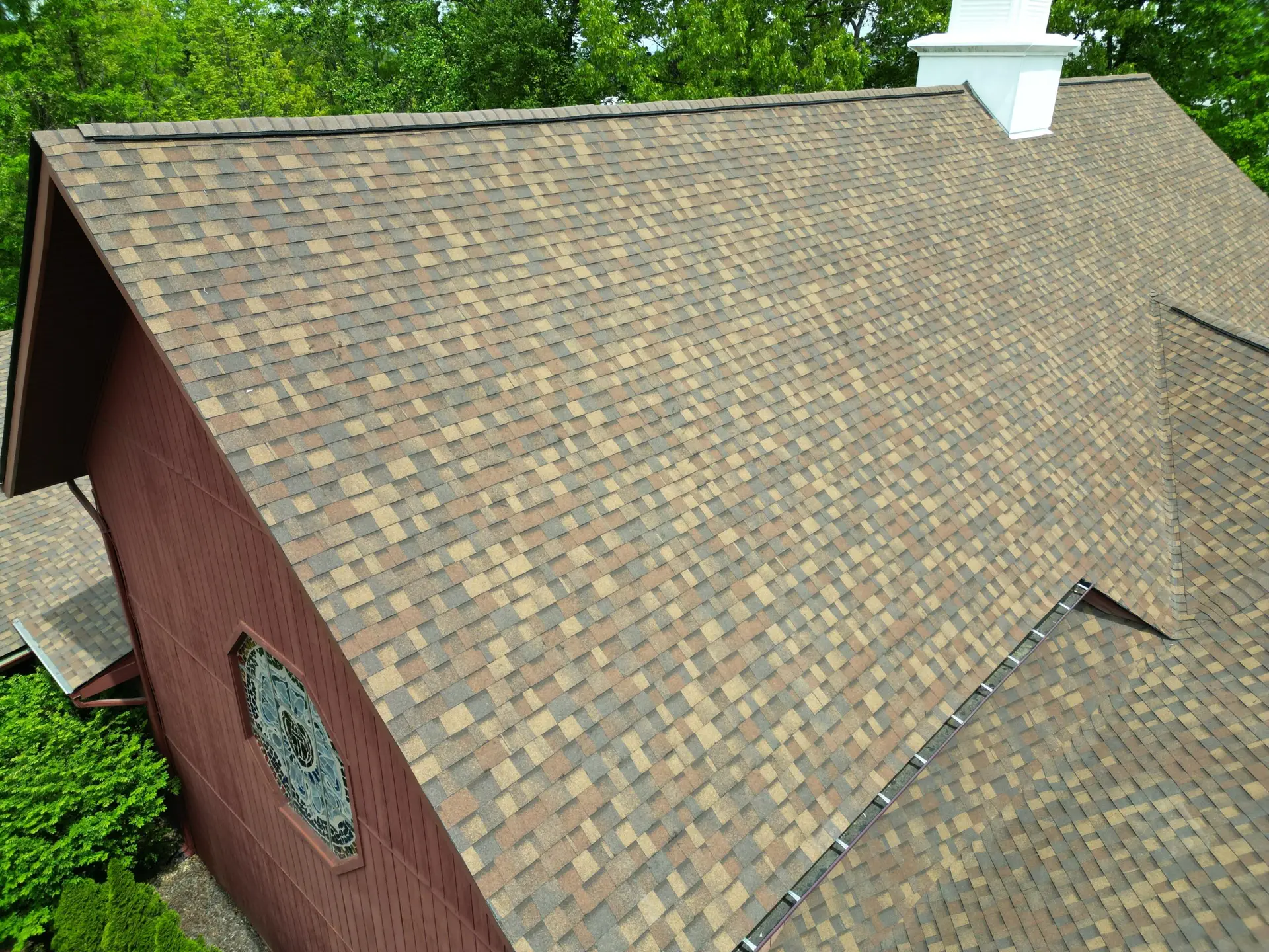 Drone view of a new Owens Corning shingle roof on a red brick church in Johnson City, TN