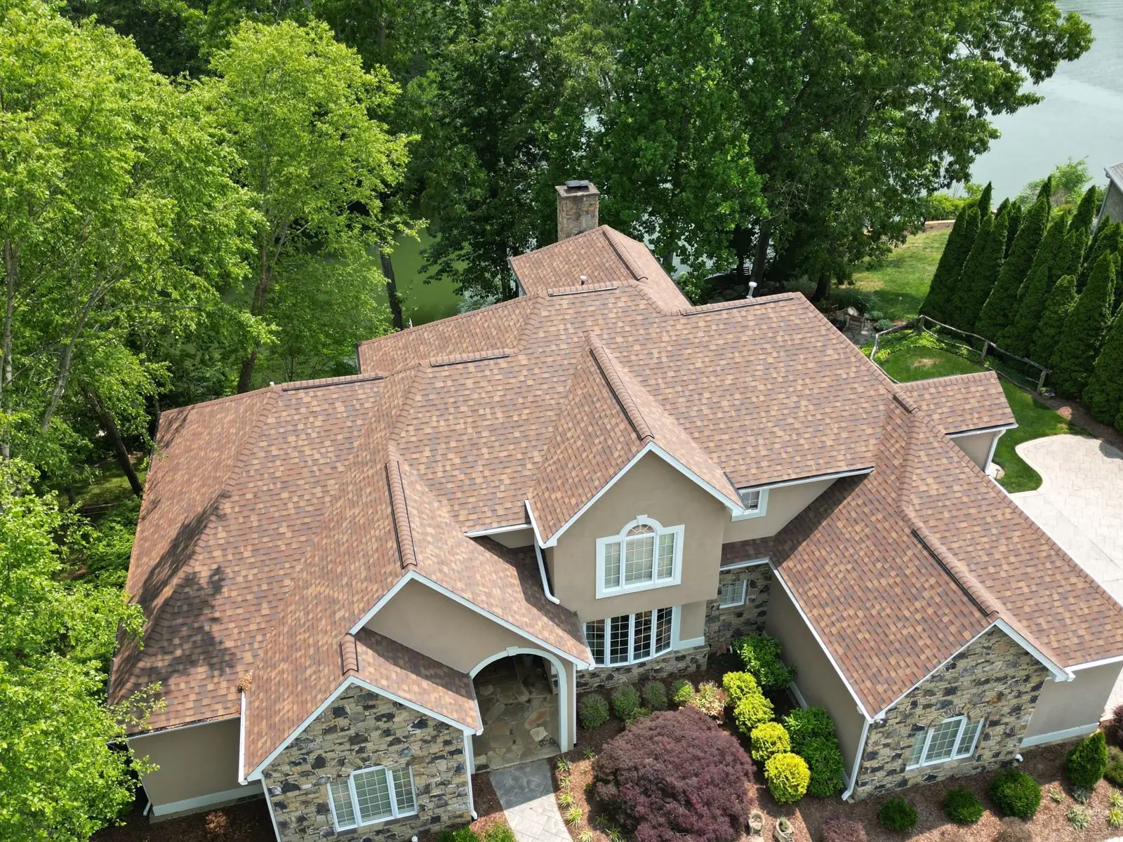 Aerial drone view of a completed residential roof replacement by Whittington Construction