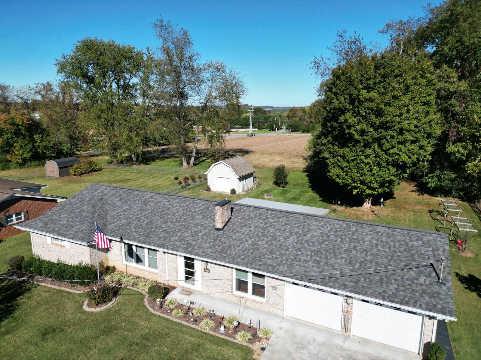 Drone view of a completed asphalt shingle roof replacement in Boones Creek