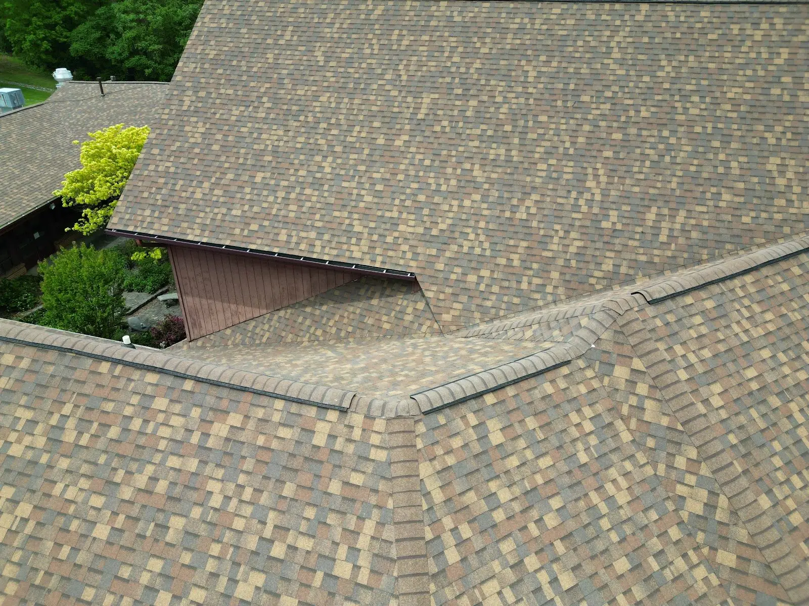 Close-up of clean roof valley transitions and ridge cap installation by Whittington Construction