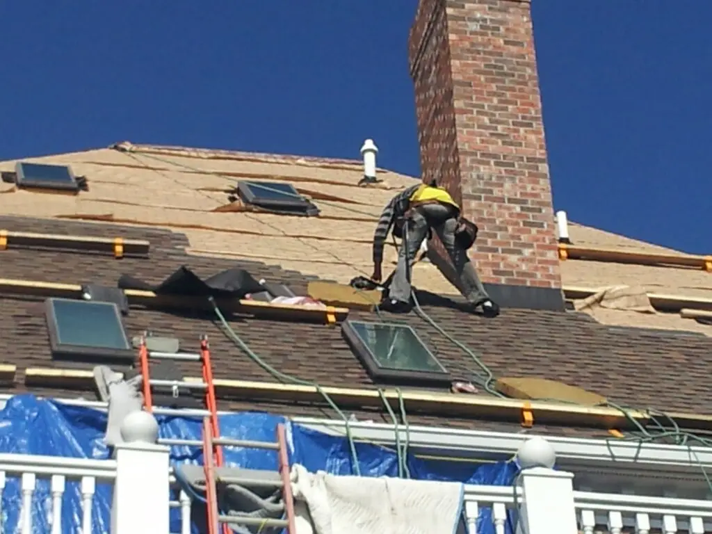 Whittington Construction roofer installing a skylight during a roof replacement