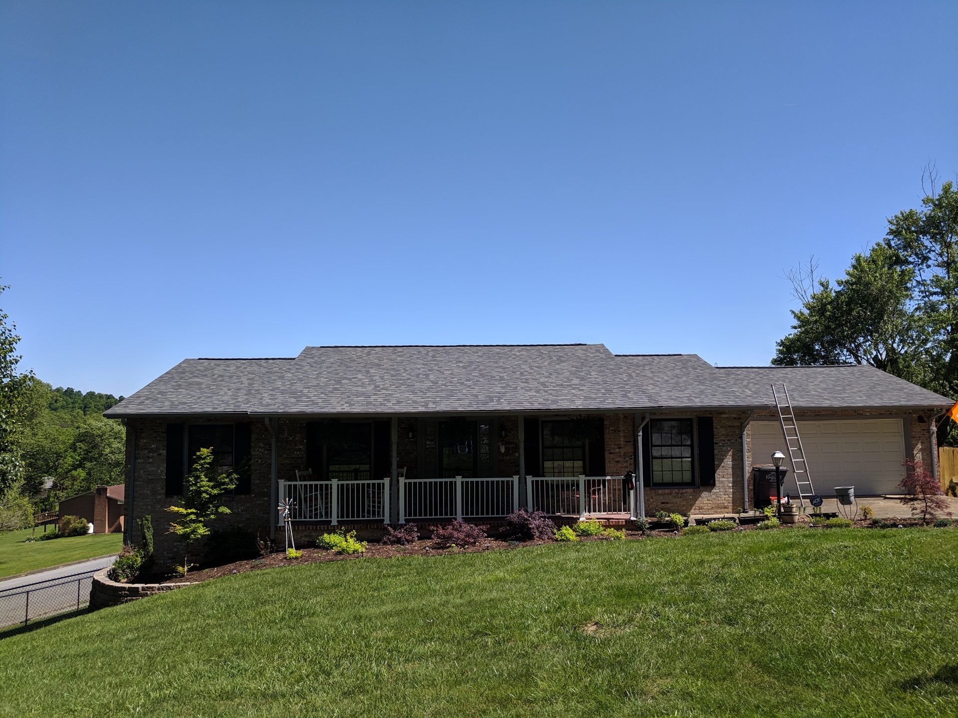 New architectural shingle roof on a brick ranch home with a front porch in Blountville, TN