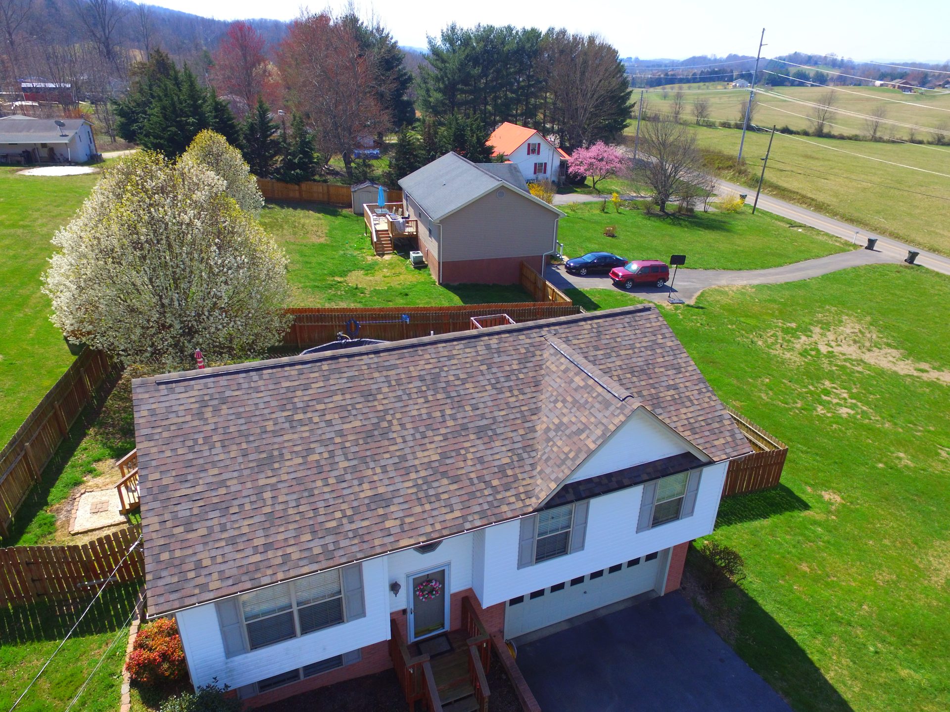 Drone view of a new shingle roof on a split-level home in the Jonesborough, TN countryside